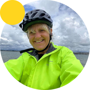 Woman in cycle helmet and yellow jacket