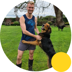 Man in shorts and gumboots with dog