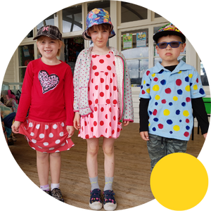 Three children in spotty clothes and hats