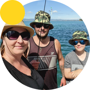 Family fishing on boat wearing hats and sunglasses